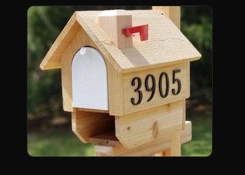 Painted cedar mailbox in light natural tone with address numbers 3905